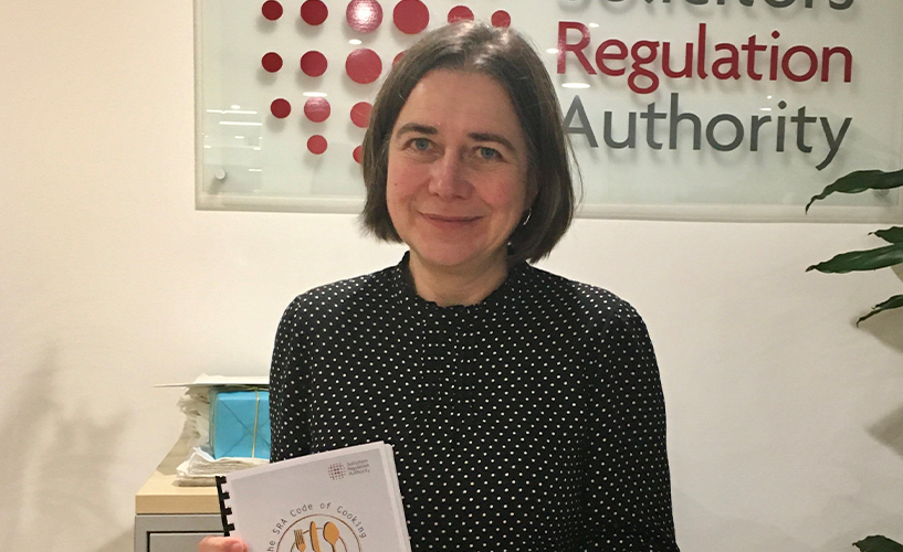 Sharon with an engraved paperweight and a copy of a collection of recipes produced by staff to raise funds for St Giles Hospice, our charity for this year.