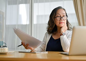 Photo of a woman holding a piece of paper